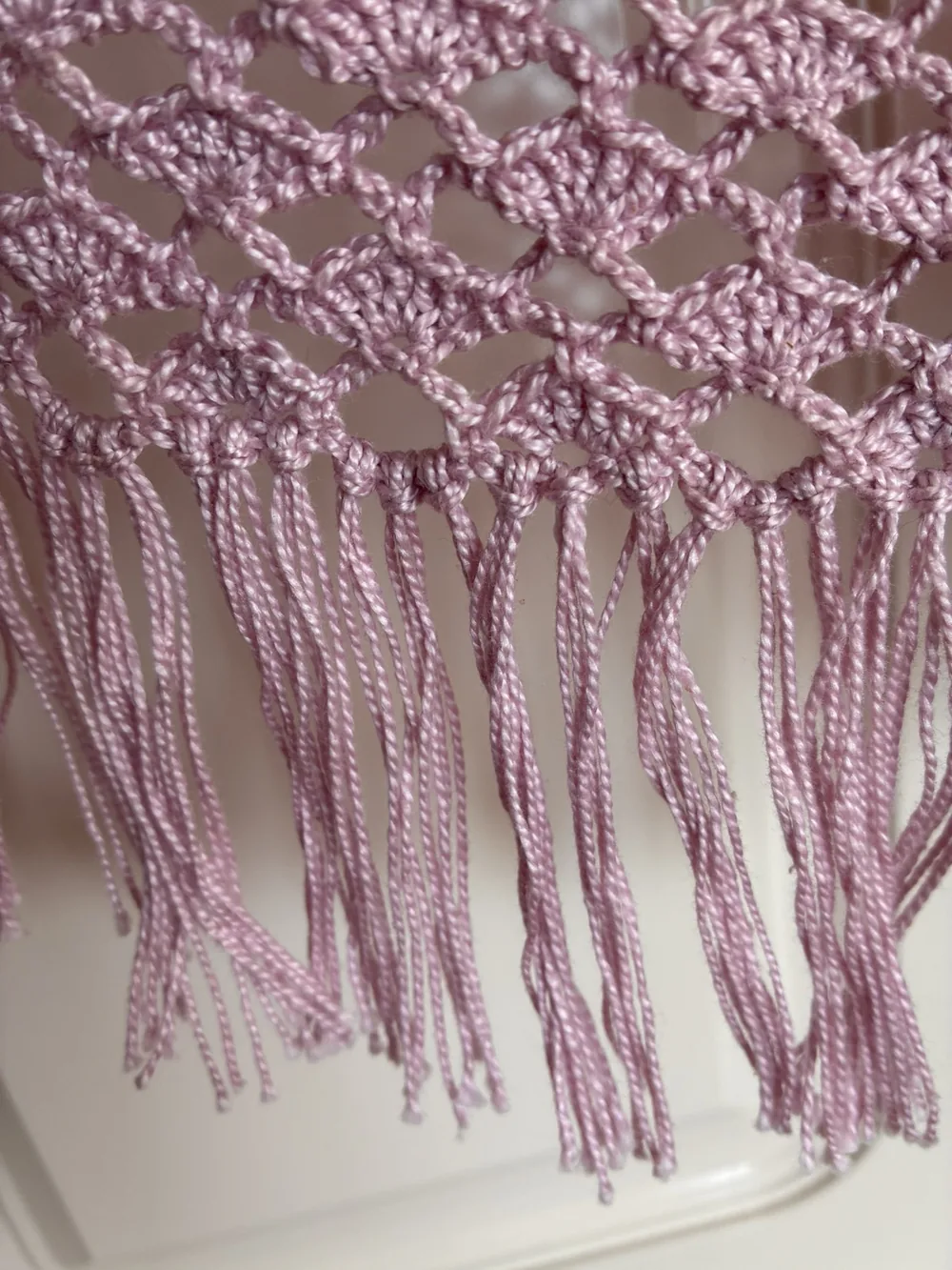 Close-up of the shell mesh and hand-tied pink fringe